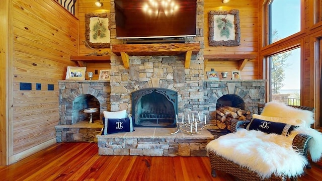 living room with a fireplace, wood finished floors, and wood walls