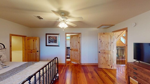 bedroom featuring wood-type flooring, baseboards, multiple windows, and a ceiling fan