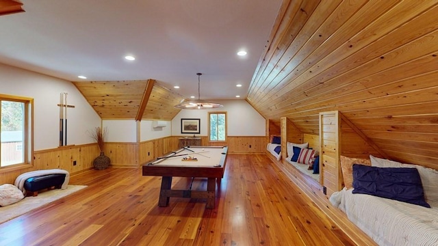 game room with a wainscoted wall, wood walls, light wood finished floors, lofted ceiling, and pool table
