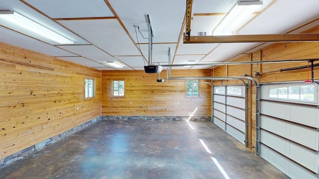 garage featuring wood walls and a garage door opener