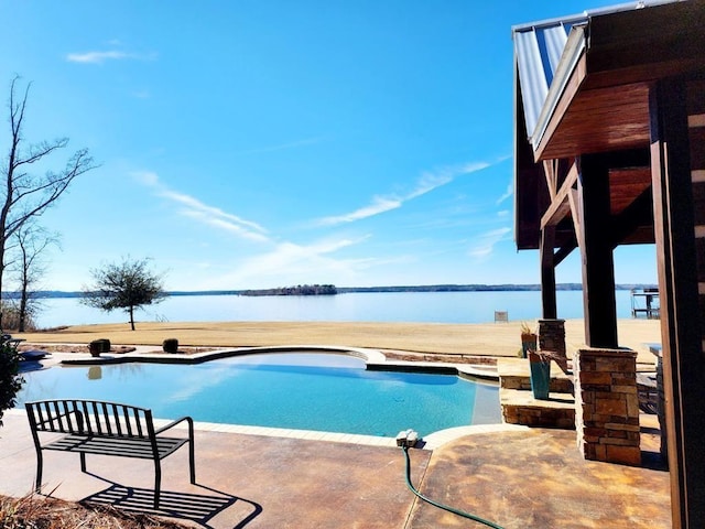 swimming pool with a water view and a patio