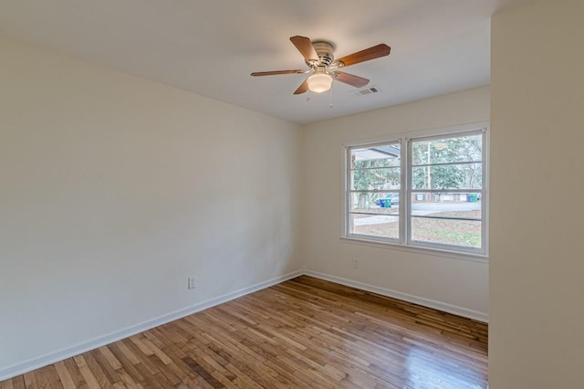 empty room with ceiling fan and light hardwood / wood-style floors