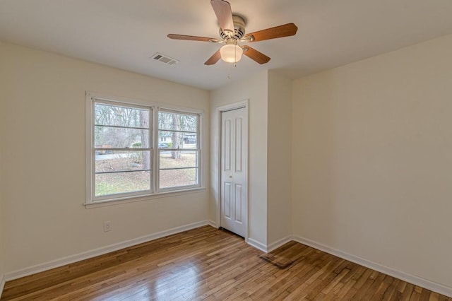 empty room featuring ceiling fan and light wood-type flooring