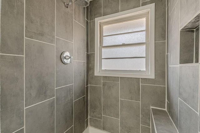 bathroom featuring a tile shower