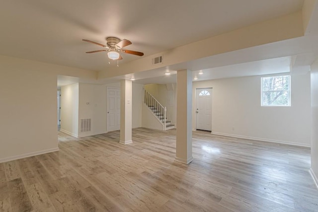 basement featuring light hardwood / wood-style flooring and ceiling fan