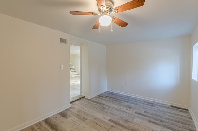 empty room featuring ceiling fan and light hardwood / wood-style flooring