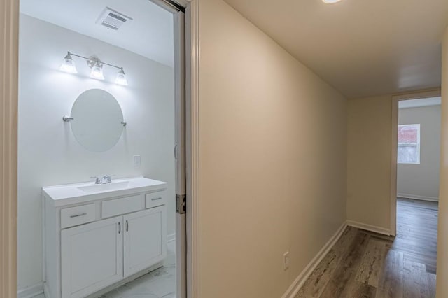 bathroom featuring hardwood / wood-style flooring and vanity