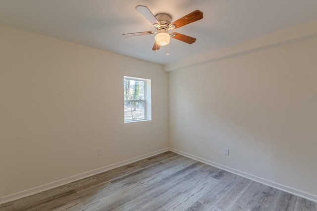 empty room with ceiling fan and light hardwood / wood-style flooring