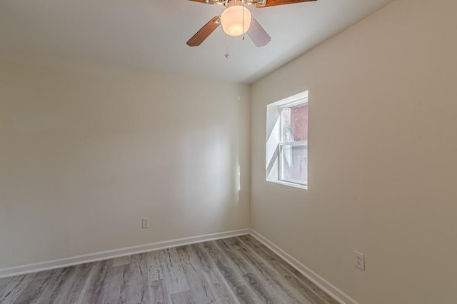 spare room featuring light hardwood / wood-style flooring and ceiling fan