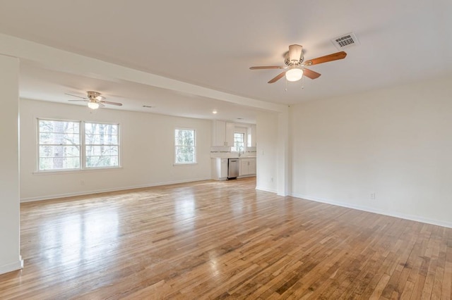 unfurnished living room with ceiling fan and light hardwood / wood-style floors