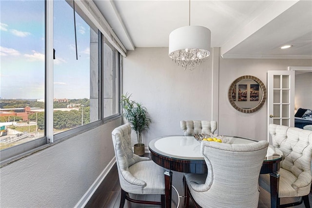 dining room with ornamental molding, dark hardwood / wood-style floors, and a notable chandelier