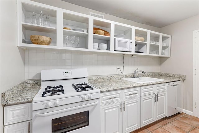 kitchen with decorative backsplash, sink, white cabinets, and white appliances