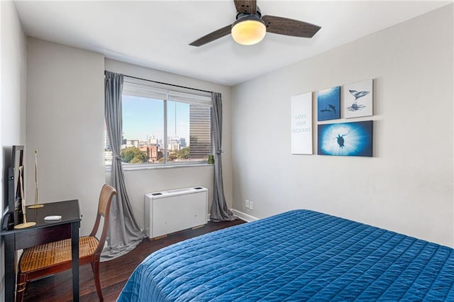 bedroom with ceiling fan and dark hardwood / wood-style flooring