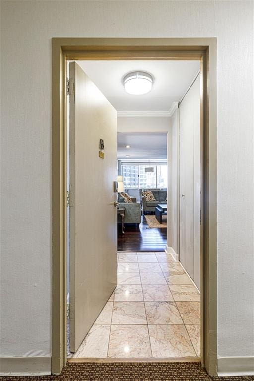 hall featuring light hardwood / wood-style floors and ornamental molding