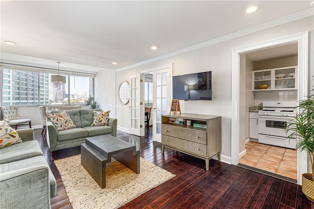 living room with hardwood / wood-style flooring and crown molding