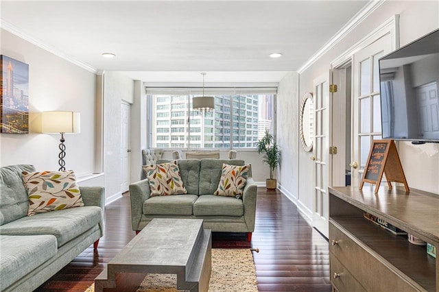 living room with dark hardwood / wood-style flooring and crown molding