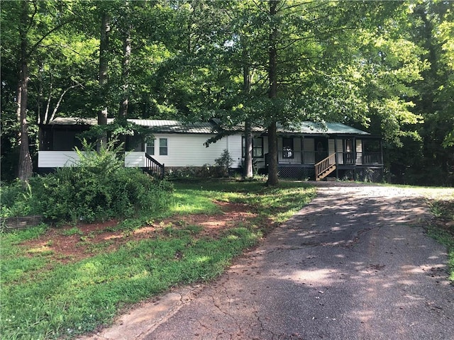 4744 Chickasaw Way SE, Acworth, GA 30102 - manufactured / mobile home with covered porch, stairs, a metal roof, and driveway