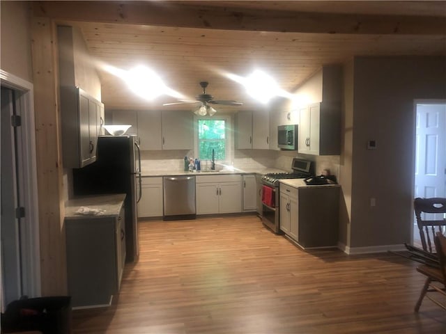 4744 Chickasaw Way SE, Acworth, GA 30102 - kitchen featuring stainless steel appliances, light wood-style floors, a ceiling fan, light countertops, and backsplash