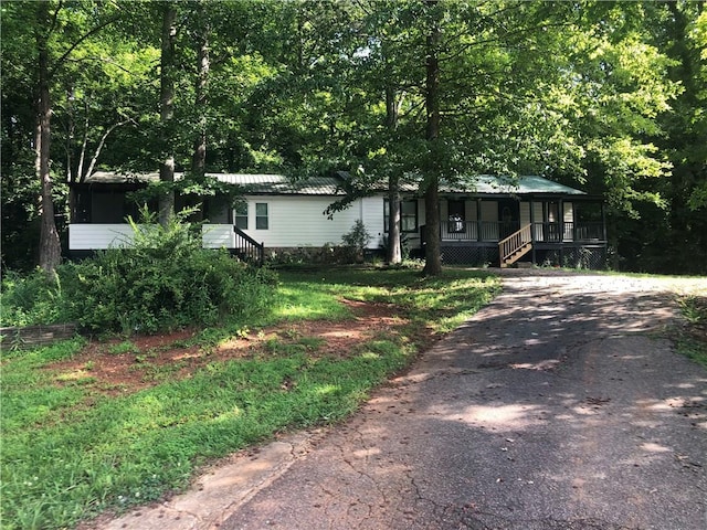 4744 Chickasaw Way SE, Acworth, GA 30102 - view of front of house featuring covered porch, asphalt driveway, stairs, and a metal roof
