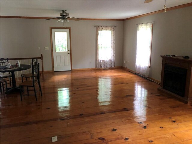 4744 Chickasaw Way SE, Acworth, GA 30102 - unfurnished living room with a ceiling fan, ornamental molding, plenty of natural light, wood-type flooring, and a fireplace