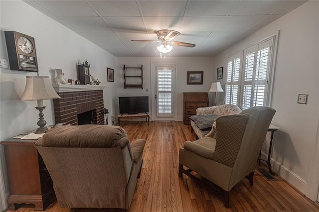 166 Etowah Dr, Cartersville, GA 30120 - living room with a fireplace, ceiling fan, baseboards, and wood finished floors