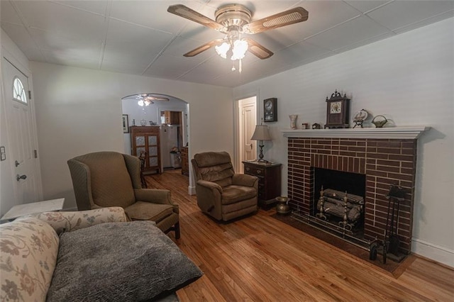 166 Etowah Dr, Cartersville, GA 30120 - living area with ceiling fan, arched walkways, wood finished floors, and a brick fireplace