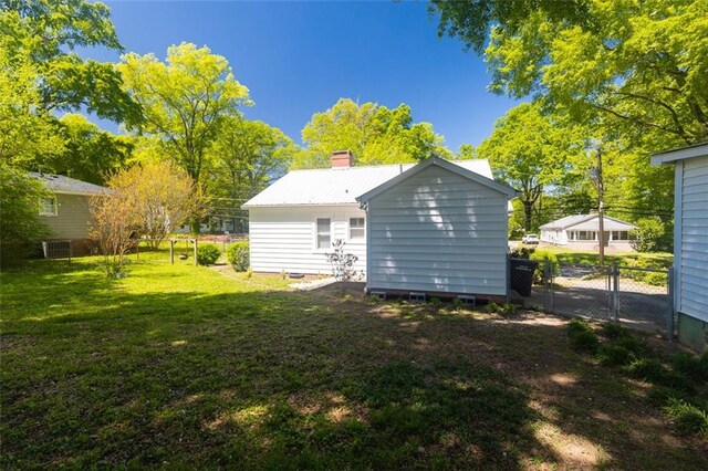 166 Etowah Dr, Cartersville, GA 30120 - rear view of house featuring a chimney, fence, and a lawn