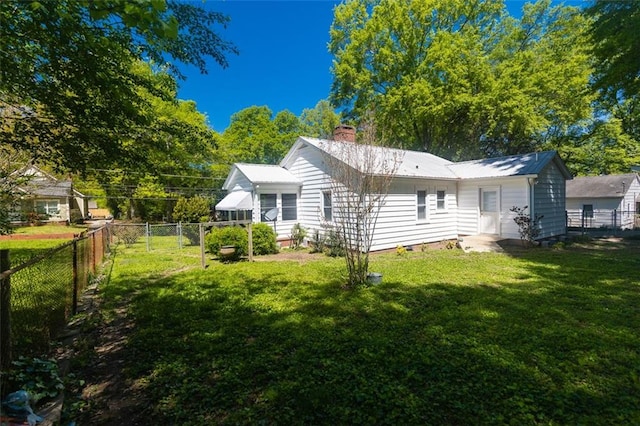 166 Etowah Dr, Cartersville, GA 30120 - rear view of property with a yard, a fenced backyard, metal roof, and a chimney