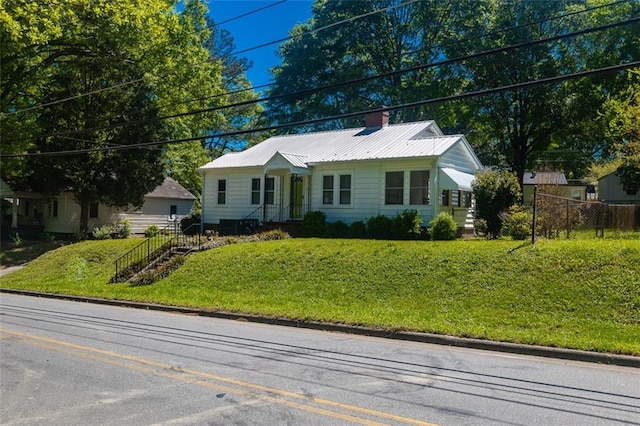 166 Etowah Dr, Cartersville, GA 30120 - view of front of property featuring a chimney, metal roof, fence, and a front lawn