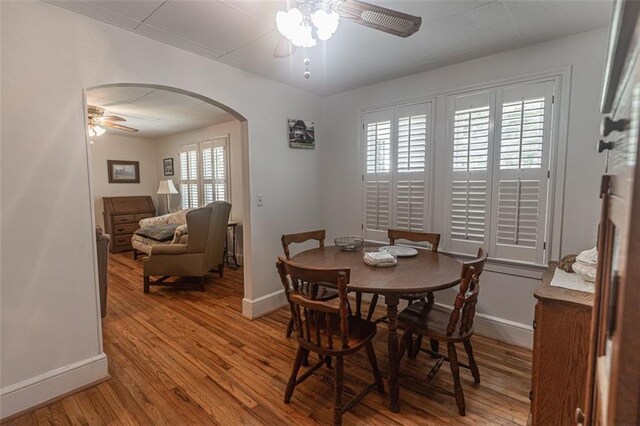 166 Etowah Dr, Cartersville, GA 30120 - dining area featuring arched walkways, wood finished floors, ceiling fan, and baseboards