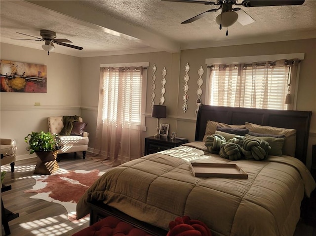 1625 Conley Rd Unit 229, Conley, GA 30288 - bedroom with a textured ceiling, multiple windows, light wood-style flooring, and ceiling fan