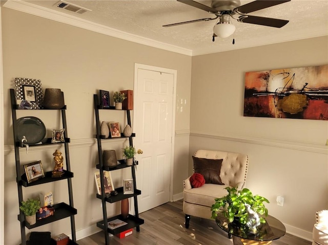 1625 Conley Rd Unit 229, Conley, GA 30288 - living area with a textured ceiling, wood finished floors, ornamental molding, and a ceiling fan