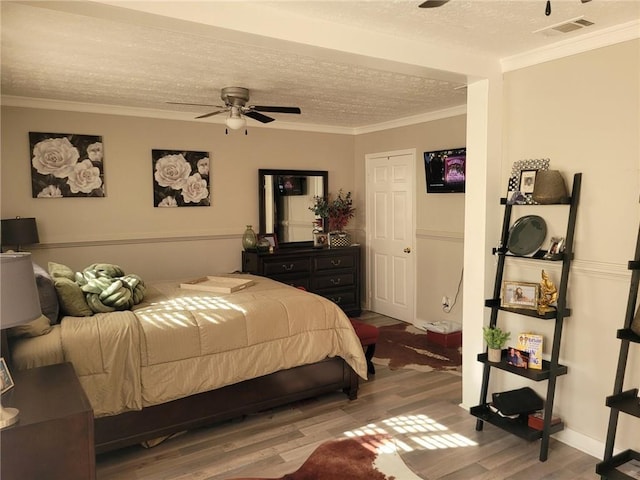 1625 Conley Rd Unit 229, Conley, GA 30288 - bedroom with wood finished floors, a textured ceiling, ceiling fan, and crown molding