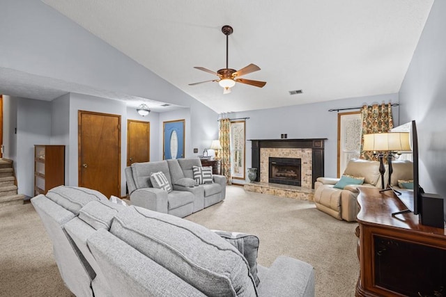 living room with a fireplace, visible vents, vaulted ceiling, stairway, and carpet