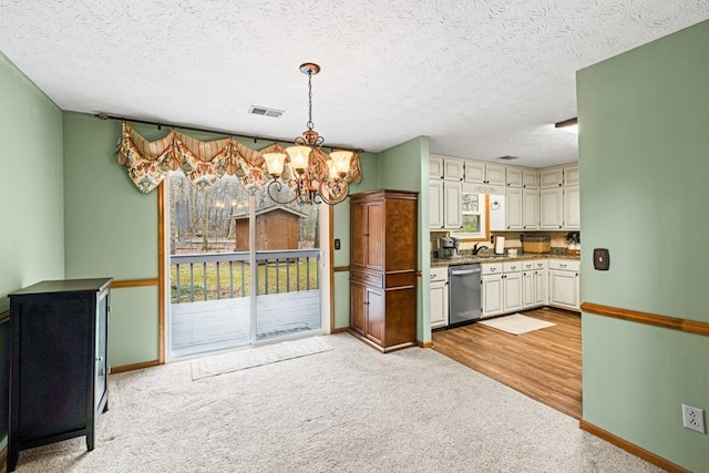 kitchen featuring a notable chandelier, light colored carpet, hanging light fixtures, visible vents, and dishwasher