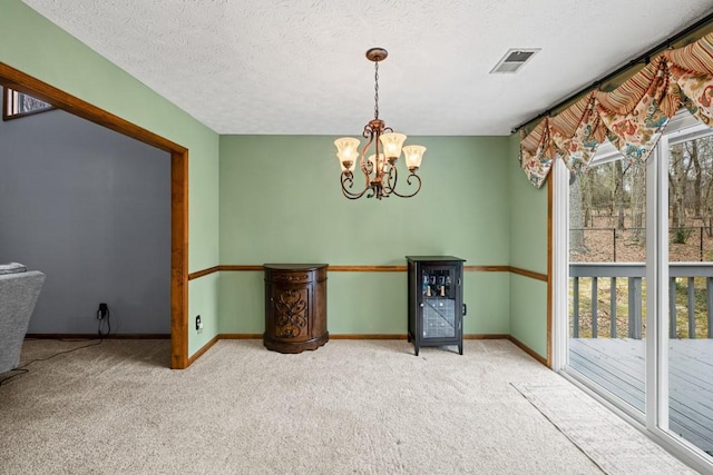 unfurnished dining area with carpet flooring, plenty of natural light, and visible vents