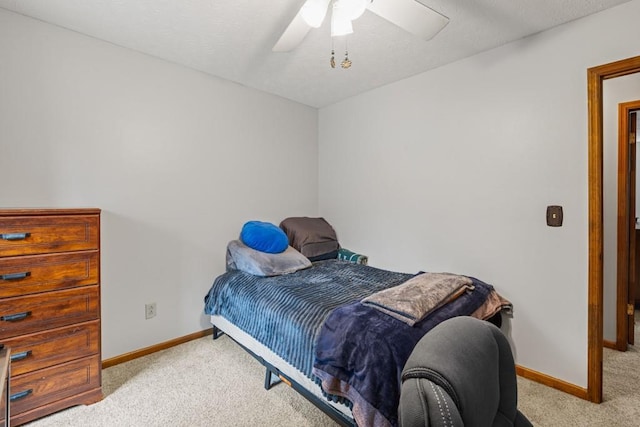 carpeted bedroom with baseboards and a ceiling fan