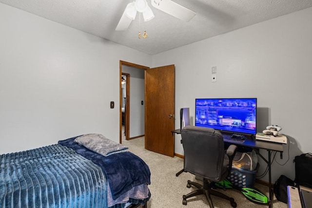 bedroom with ceiling fan, carpet floors, a textured ceiling, and baseboards