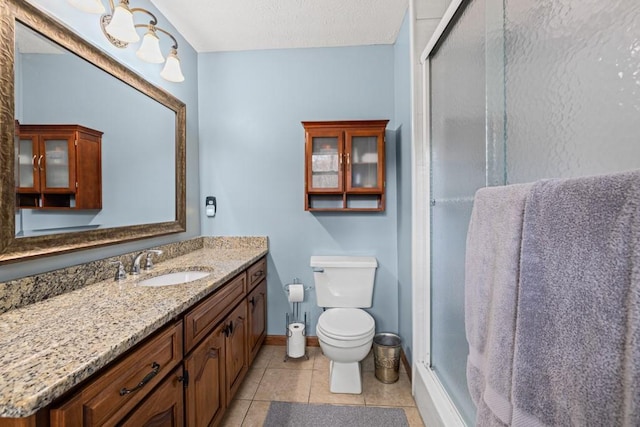 full bathroom with toilet, a textured ceiling, a shower stall, vanity, and tile patterned flooring