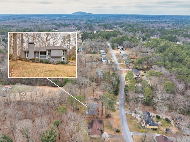 bird's eye view featuring a wooded view