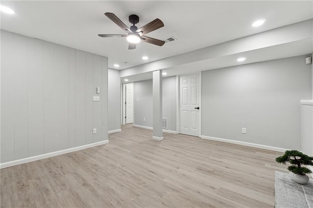 basement with light hardwood / wood-style flooring and ceiling fan