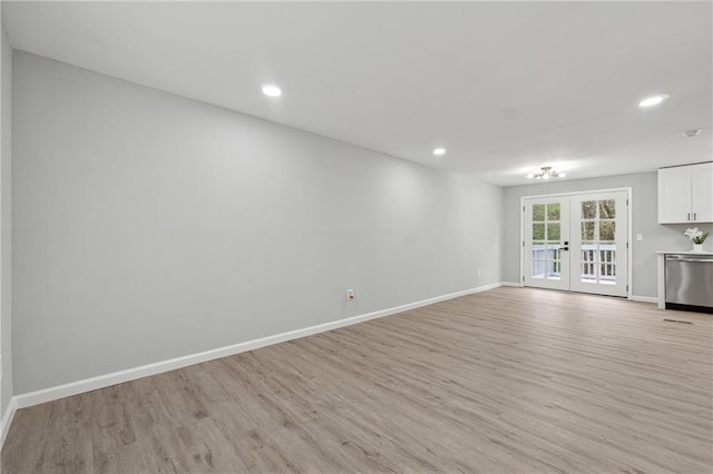 unfurnished living room featuring french doors and light hardwood / wood-style floors