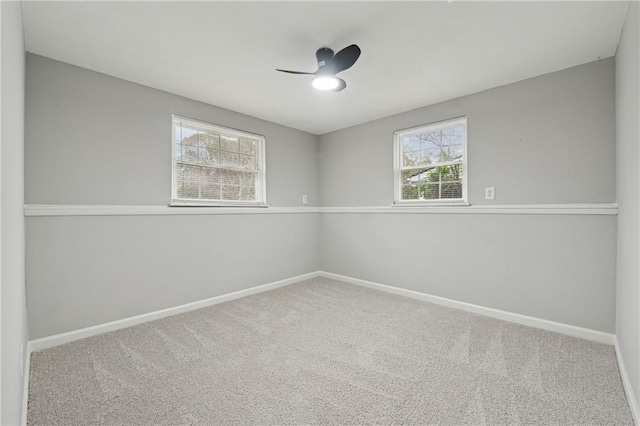 carpeted spare room with ceiling fan