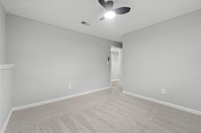 carpeted empty room featuring ceiling fan