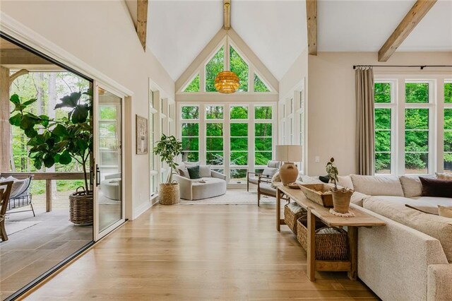 sunroom with french doors, beamed ceiling, and a healthy amount of sunlight