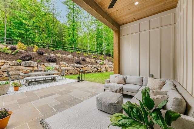 view of patio featuring ceiling fan, an outdoor living space, and a fenced backyard