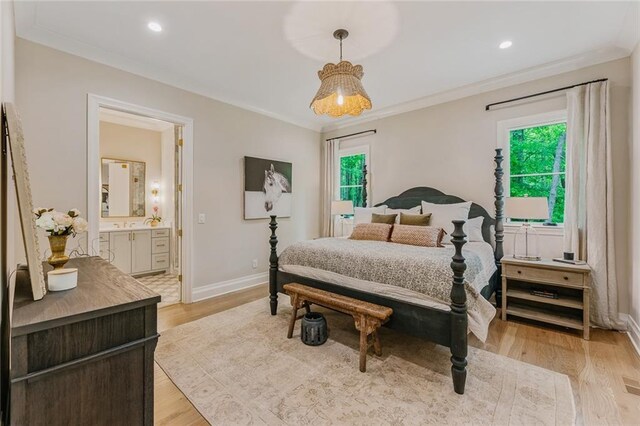 bedroom featuring baseboards, ornamental molding, connected bathroom, and multiple windows