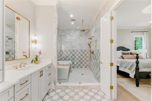 ensuite bathroom with visible vents, a stall shower, ensuite bath, and ornamental molding