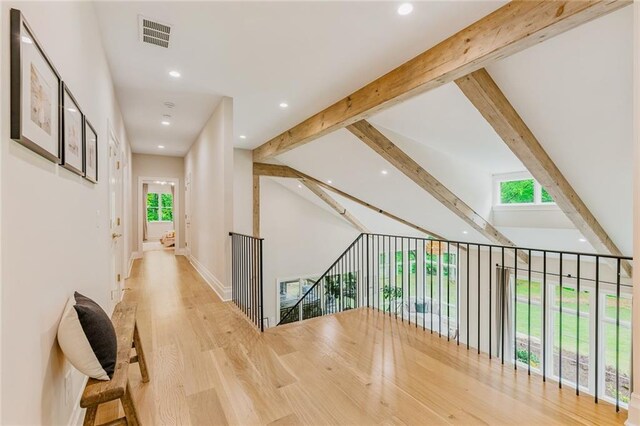 hall featuring plenty of natural light, recessed lighting, wood finished floors, and visible vents