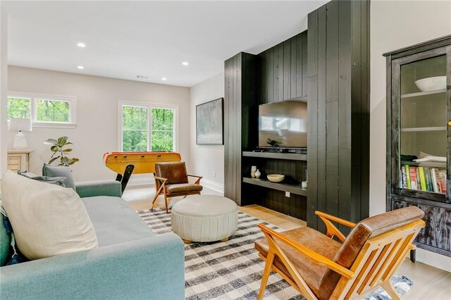 living area with recessed lighting, light wood finished floors, and baseboards